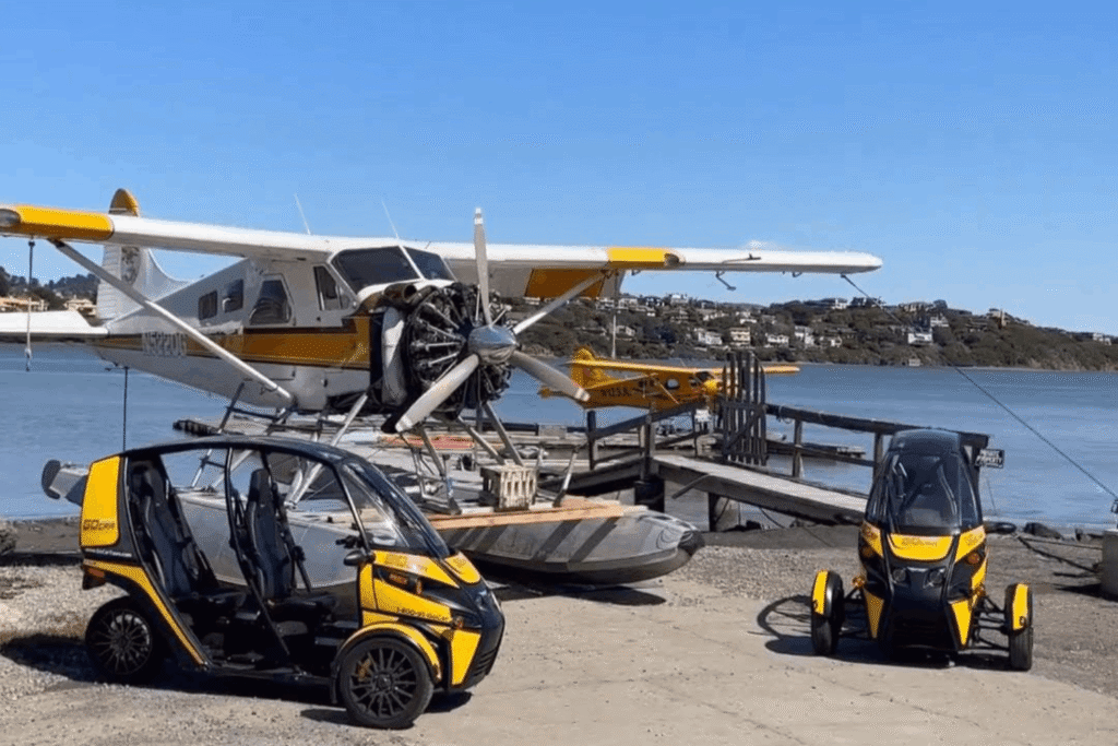 GoCar Tours | Sightseeing & Story Telling Car Muir Woods Tour from San Francisco: The Ultimate Land, Sea & Air Day Trip 1 two gocars in front of a seaplane in san francisco