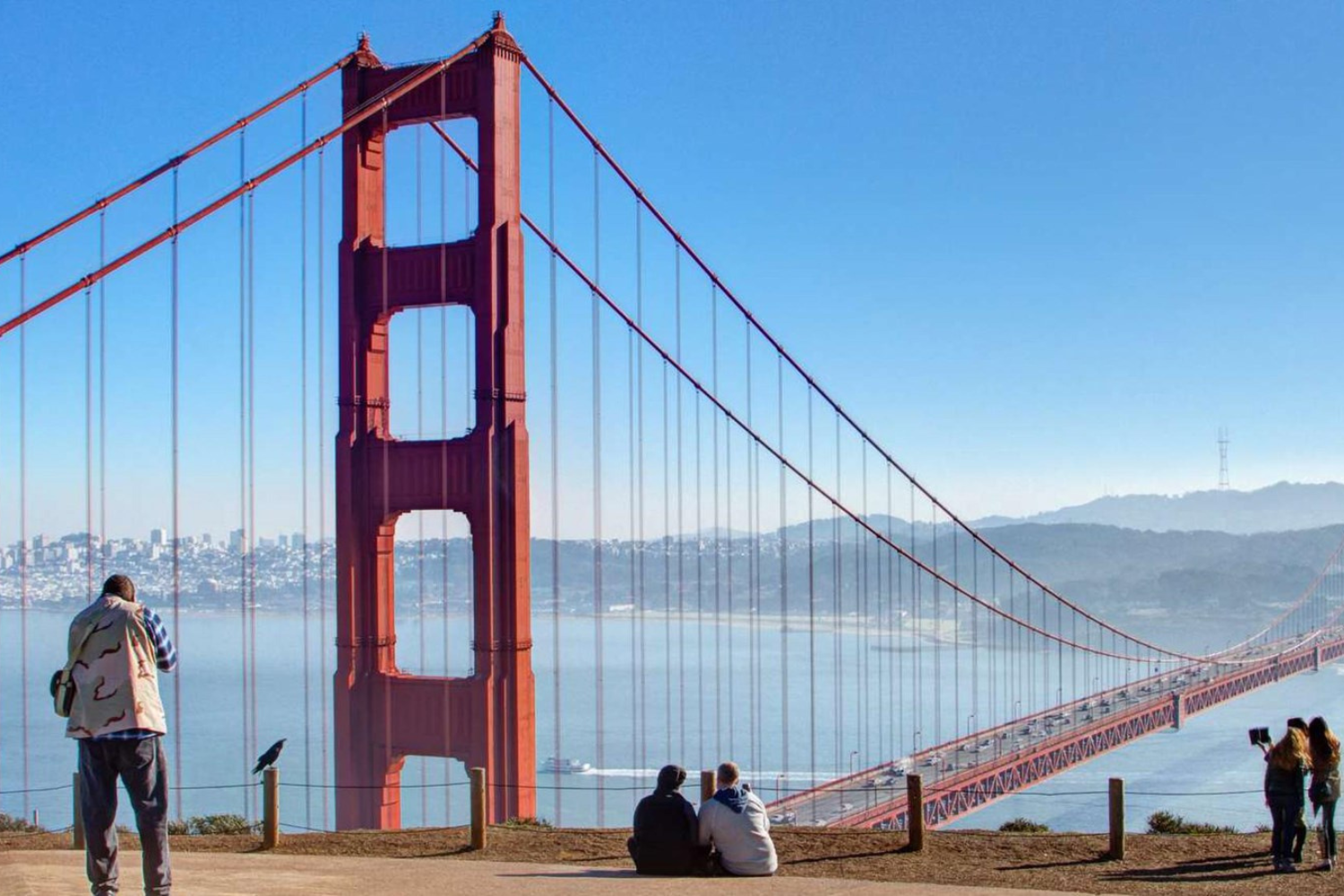 people looking out at the golden gate bridge from a san francisco viewpoint